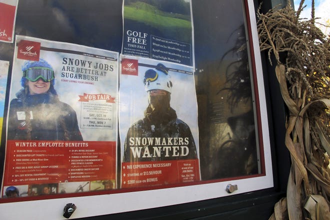 In this Oct. 23, 2019, photo, posters advertising ski season jobs and a job fair are displayed on a bulletin board a at Sugarbush Resort in Warren, Vermont. In a tight labor market, ski areas are having a tough time hiring seasonal workers so they're upping the ante by boosting wages, offering more worker housing and other incentives. (AP Photo/Lisa Rathke)