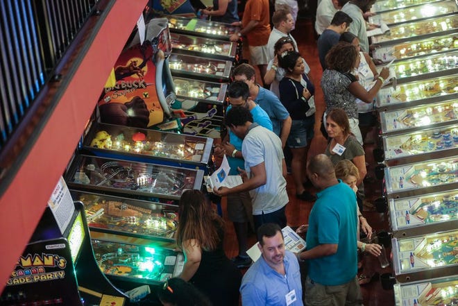 People play vintage pinball and arcade games inside the Silverball Museum in Delray Beach. [DAMON HIGGINS/palmbeachpost.com]