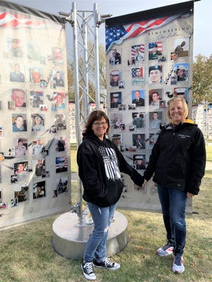 Pictured (L-R) Sheila Hachmeister, Natoma, and Noala Fritz standing beside a photograph of her son, 1st Lt. Jacob Fritz, a West Point graduate.
