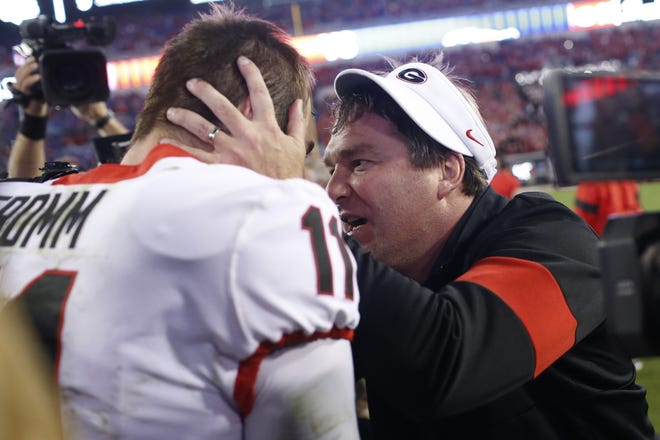 Georgia coach Kirby Smart celebrates with quarterback Jake Fromm (11) after the team's 24-17 win over Florida on Saturday in Jacksonville, Florida. [JOSHUA L. JONES/ATHENS BANNER-HERALD VIA AP]