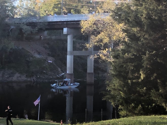 Rescue personnel search for a body Sunday, Nov. 3, 2019, in the Cape Fear River near the Person Street bridge. [Rachael Riley/The Fayetteville Observer]