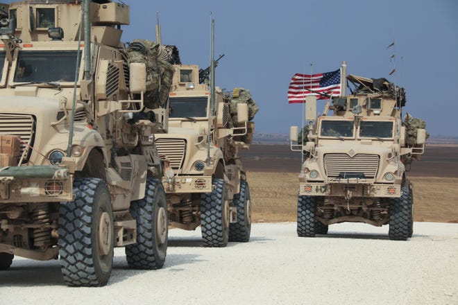 An American military convoy stops near the town of Tel Tamr in north Syria on Sunday, Oct. 20, 2019. [AP Photo/Baderkhan Ahmad]