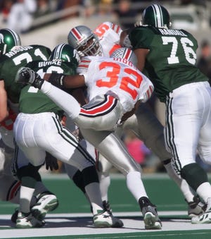 Ohio State linebacker Na'il Diggs flies around the Michigan State's offensive line to try to sack quarterback Bill Burke during their game at Spartan Stadium on Nov. 6, 1999. [File photo]