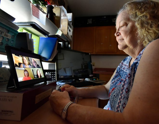 Linda Cravey participates in a virtual caregiver support group meeting through Jacksonville-based ElderSource on her tablet at her Fernandina Beach home. Cravey is the caregiver for her husband Larry, who has dementia. [Will Dickey/Florida Times-Union]