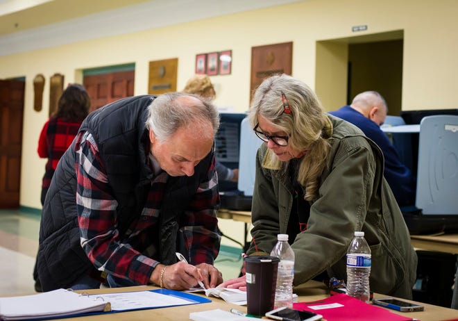 Bill Kisto, left, signs in to vote with poll station worker Linda Storry at the Sparta Volunteer Fire Department Tuesday in Sparta. [Photo by Daniel Freel/New Jersey Herald (NJH)]