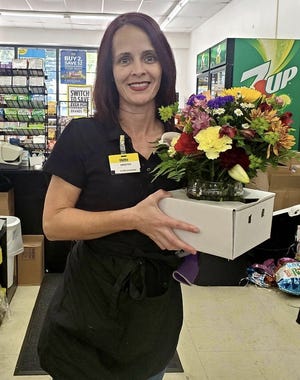 Kristen Mcguire, manager at Dollar General in Bluffton, recently received a bouquet of flowers for her support of programs in the Jasper County community. [Photo courtesy of Glenda Brown]
