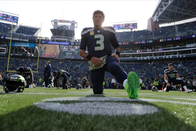 Seattle quarterback Russell Wilson has had a huge first half of the season, with 22 touchdown passes against only one interception. [JOHN FROSCHAUER/THE ASSOCIATED PRESS]