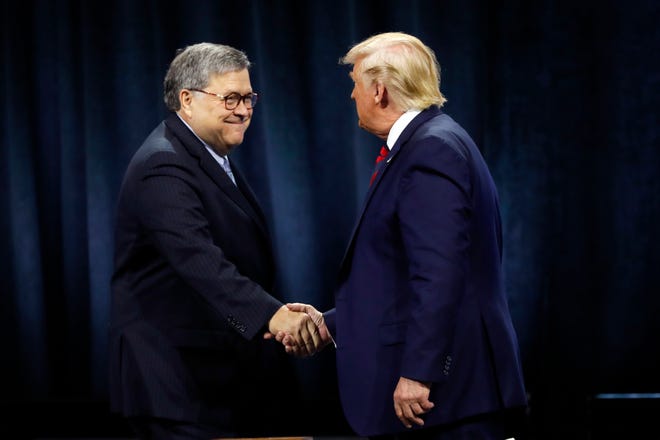 President Donald Trump shakes hands with U.S. Attorney General William Barr before Trump signed an executive order creating a commission to study law enforcement and justice at the International Association of Chiefs of Police Convention Monday, Oct. 28, 2019, in Chicago. (AP Photo/Charles Rex Arbogast)