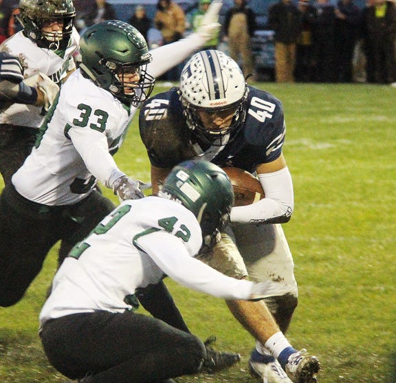 Fieldcrest's Kenton Castrejon, picking up yards here last week, will be a workhorse for the Knights against St. Edward in a Class 2A playoff game.
