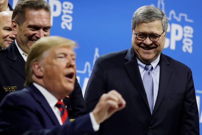 President Donald Trump speaks while signing an executive order during the International Association of Chiefs of Police Annual Conference and Exposition, at the McCormick Place Convention Center Chicago, Monday, Oct. 28, 2019, in Chicago, as Attorney General William Barr looks on, right. (AP Photo/Evan Vucci)