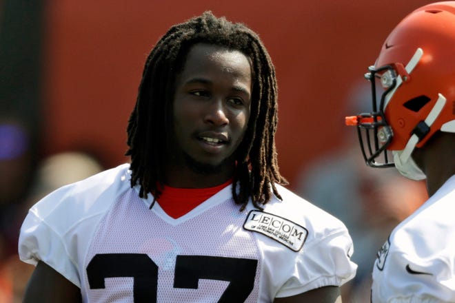 FILE - In this July 25, 2019, file photo, Cleveland Browns running back Kareem Hunt, left, talks with running back Nick Chubb during practice at the NFL football team's training camp facility, in Berea, Ohio. Hunt’s self-inflicted punishment is over. The Browns running back, who quickly went from being one of the NFL’s rising stars to a violent offender, has returned from his eight-game NFL suspension and will play this week against the Buffalo Bills. (AP Photo/Tony Dejak, File)