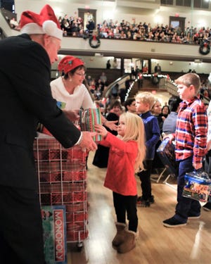 Children donate gifts to the Children's Holiday Fund at the annual Holiday Pops concerts by the Plymouth Philharmonic Orchestra. [Wicked Local File Photo/Denise Maccaferri]