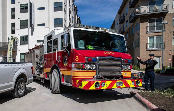 Firefighter Mike Abernethy from the Austin Fire Department Station No. 8, drives a fire truck in narrow Austin streets in Austin on Oct. 31. [LOLA GOMEZ / AMERICAN-STATESMAN]