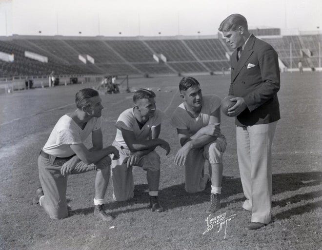 Texas football coach Jack Chevigny, right, speaks to Longhorns players. He was head coach from 1934 to 1936. Chevigny, who would later join the U.S. Marines, died at Iwo Jima in World War II at age 38. [UNIVERSITY OF TEXAS]