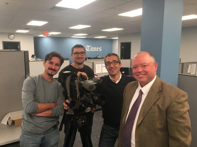 Times reporter J.D. Prose, right, in The Times newsroom on Nov. 4 with the TV3 news crew filming a segment on Beaver County for the Spanish broadcast channel. [Daveen Kurutz/BCT staff]