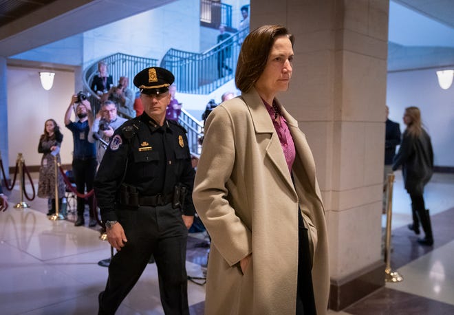 Former top Russia adviser Fiona Hill, one of the first White House officials to cooperate in Democrats' investigation of the Ukraine scandal, returns to a secure area in the Capitol where she testifies last month to House impeachment investigators, in Washington on Monday. Hill worked for former national security adviser John Bolton. [J. SCOTT APPLEWHITE/THE ASSOCIATED PRESS]