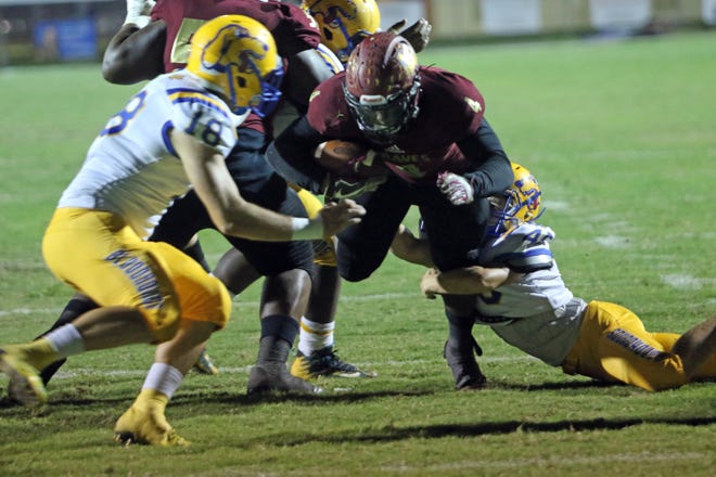 Lake Gibson running back Jaylon Glover plows up the middle for a touchdown in the second quarter against Auburndale on Friday night in the Class 6A, Region 3 quarterfinals at Virgil Ramage Stadium. [ROY FUOCO/THE LEDGER]