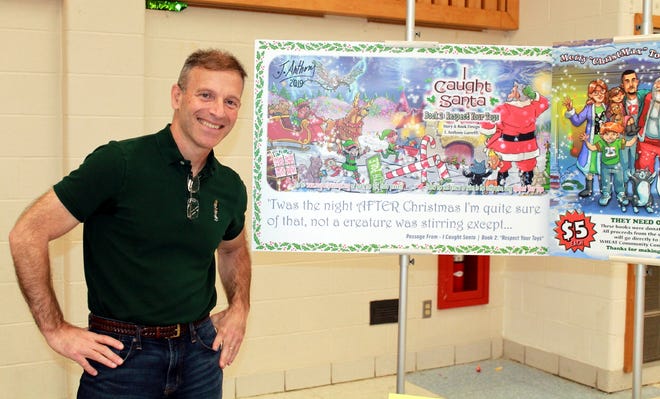 J. Anthony Garreffi unveiled his second book in the 'I Caught Santa' series at the Nov. 2 Clinton Middle School Harvest Fair. Proceeds benefit WHEAT Community Connections. [Item Staff/JAN GOTTESMAN]