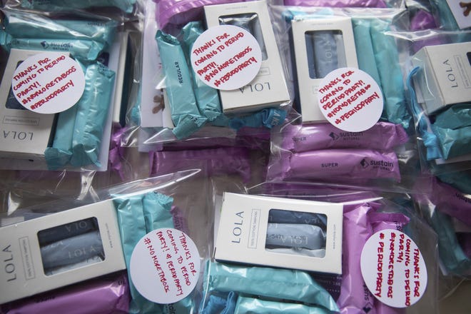 A Senate bill signed into law by Ohio Gov. Mike DeWine on Nov. 6 ends the taxing of feminine hygiene products, dubbed the "pink tax," on April 1, 2020. In this file photo, sponsored giveaways of menstrual products are featured at a 2018 Period Party on World Menstrual Hygiene Day in New York. [Jackie Molloy/The New York Times]