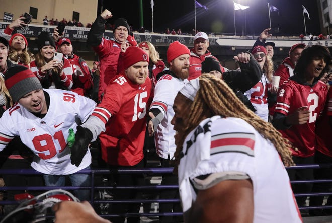 Ohio State Buckeyes fans cheer as Ohio State Buckeyes defensive end Chase Young (2) leaves the field following the Buckeyes' 52-3 victory against the Northwestern Wildcats during a NCAA Division I college football game on Friday, Oct. 18, 2019 at Ryan Field in Evanston, Illinois. [Joshua A. Bickel/Dispatch]