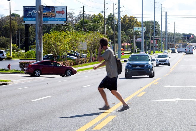 A man darts out in front of traffic on U.S. Highway 27/441 in Leesburg on Thursday. The 1.2 miles of U.S. Highway 441/27 that runs from Martin Luther King Jr. Boulevard south to where the two highways split near Griffin Road has been an ongoing issue with pedestrians and accidents. [Cindy Sharp/Correspondent]