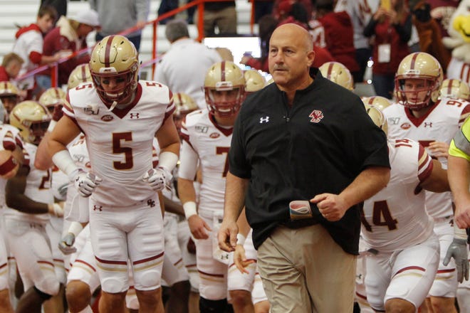 Boston College head coach Steve Addazio runs onto the field with his team before a game against Syracuse on Saturday in Syracuse, N.Y. [Nick Lisi/The Associated Press]