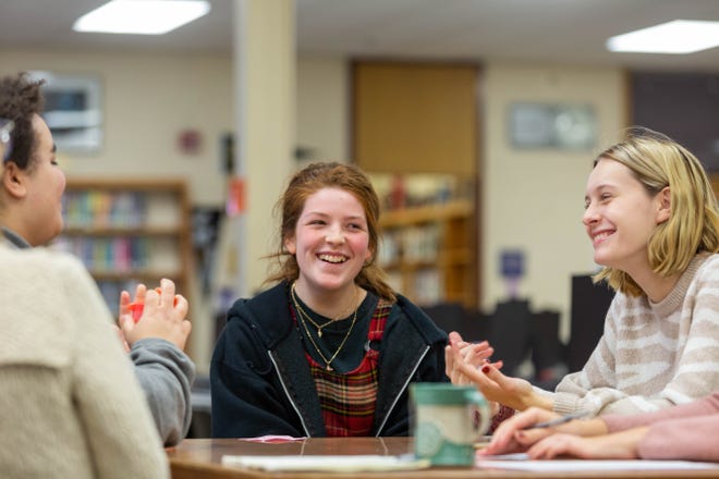 Elaina Wright, right, a junior at Topeka West, chats with Akoya Peters, middle, also a junior, and Danielle Carter, senior, Tuesday in the Topeka West library. [Evert Nelson/The Capital-Journal]