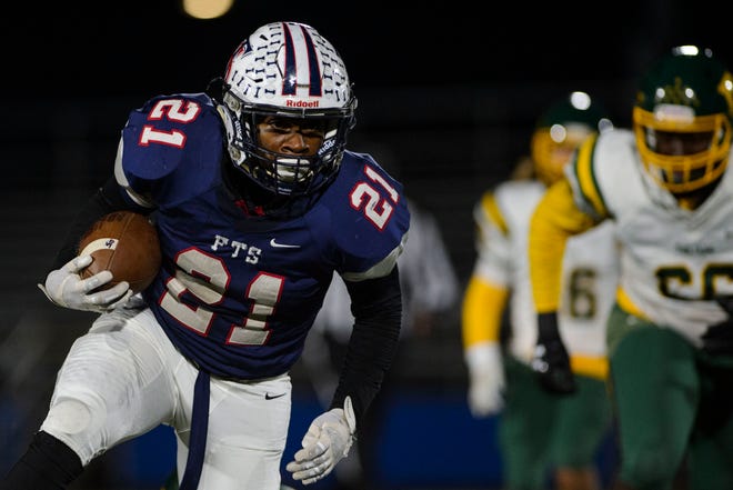 Terry Sanford's Dorian Clark runs for a first down before scoring a touchdown during Friday’s game against Pine Forest. Clark ran for four TDs in the game. [Melissa Sue Gerrits/The Fayetteville Observer]