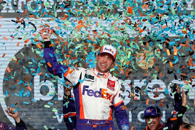 Denny Hamlin celebrates in Victory Lane after winning the NASCAR Cup Series race Sunday in Avondale, Ariz. [AP Photo/Ralph Freso]