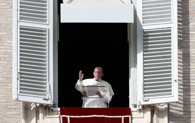 Pope Francis delivers his message during his Angelus prayer from his studio window overlooking St. Peter's Square at the Vatican on Sunday. [GREGORIO BORGIA/THE ASSOCIATED PRESS]