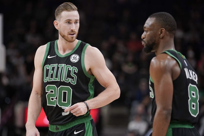 Celtics forward Gordon Hayward (left) talks to teammate Kemba Walker during the first half of Boston's 135-115 win over the Spurs on Saturday. Hayward left the game late in the first half with an apparent broken hand. [AP Photo/Darren Abate]
