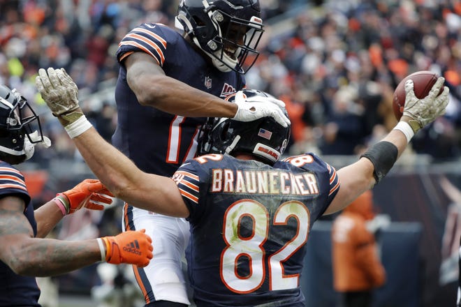 Chicago Bears tight end Ben Braunecker (82) celebrates his 18-yard touchdown reception with Anthony Miller (17) during the first half against the Detroit Lions in Chicago, Sunday. [CHARLES REX ARBOGAST/THE ASSOCIATED PRESS]