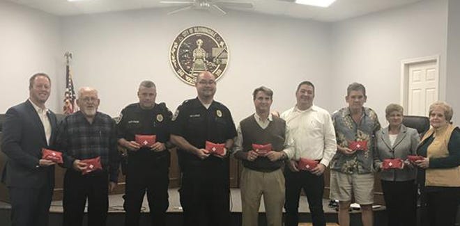 From left: Bloomingdale City Councilman Gene Harley, Councilman Ernest Gizzard, Capt. Foune, Chief Blair Jeffcoat, Dr. Stephen Pohl, Councilman David Otakie, Mayor Ben Rozier, Councilwoman Barbara Griffin, and Councilwoman Virginia Key with some of the 20 emergency medical kits donated by Pohl. [Provided photo]