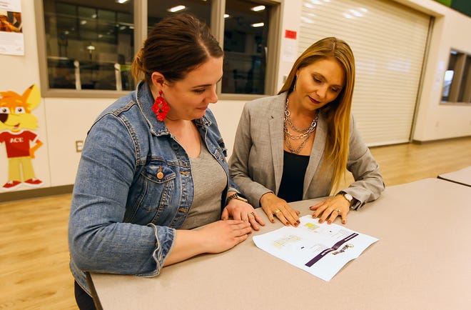 Principal Kate Shaum and district communications director Tamra Spence review plans for the Windermere Elementary School connector project. [PHOTO BY ARIANA GARCIA]