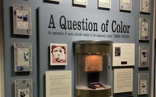 The Akron Beacon Journal's Pulitzer Prize medal, awarded in 1994 for the newspaper's “A Question of Color” series, is displayed in the former newsroom at 44 E. Exchange St. The medal was reported stolen this week. [Jim Mackinnon/Beacon Journal file photo]