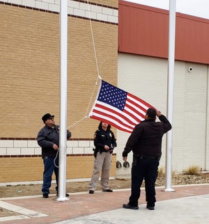 South Plains College Lubbock Center police officers Teresea Armenta and JR Rosales, and maintenance supervisor Jose Ramirez, raise the United States flag Monday during a Veteran’s Day ceremony on campus. [A-J Media/Gabriel Monte]