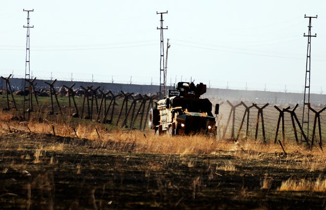 In this photo taken from the outskirts of the village of Alakamis, in Idil province, southeastern Turkey, a Turkish army vehicles is driven in Turkey after conducting a joint patrol with Russian forces in Syria, Friday, Nov. 8, 2019. The Britain-based Syrian Observatory for Human Rights says a protester has been killed when he was run over in the village of Sarmasakh, Syria near the border by a Turkish vehicle during a joint patrol with Russia.The man was among residents who pelted with shoes and stones Turkish and Russian troops who were conducting their third joint patrol in northeastern Syria, under a cease-fire deal brokered by Moscow that forced Kurdish fighters to withdraw from areas bordering Turkey. (AP Photo/Mehmet Guzel)