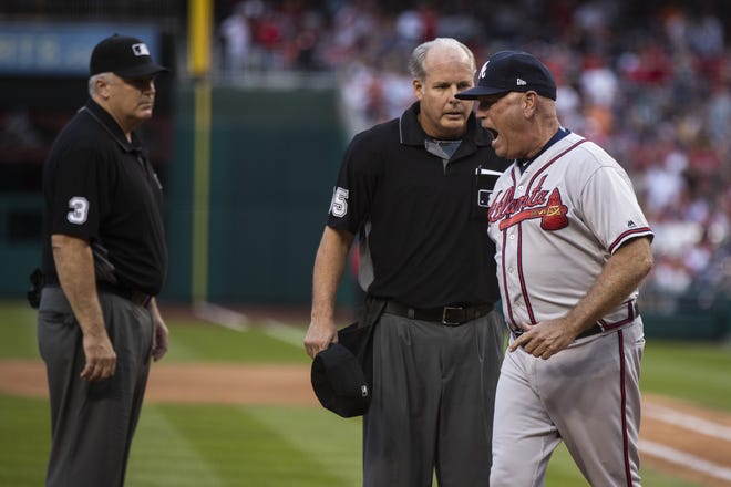 Atlanta Braves manager Brian Snitker, right argues with umpires Bill Welke, left, and Tim Timmons, center, after being thrown out during the seventh inning of a game between the Nationals and the Braves in Washington on Sept. 14. Snitker is one of three finalists for the National League Manager of the Year award to be announced Tuesday. [MANUEL BALCE CENETA/AP FILE PHOTO]