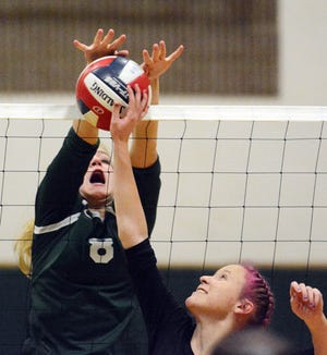 Griswold's Audrey Strmiska blocks a return from Montville's Mackenzie Clark during the Wolverines' 3-0 CIAC first round win in Griswold. [John Shishmanian/ NorwichBulletin.com]