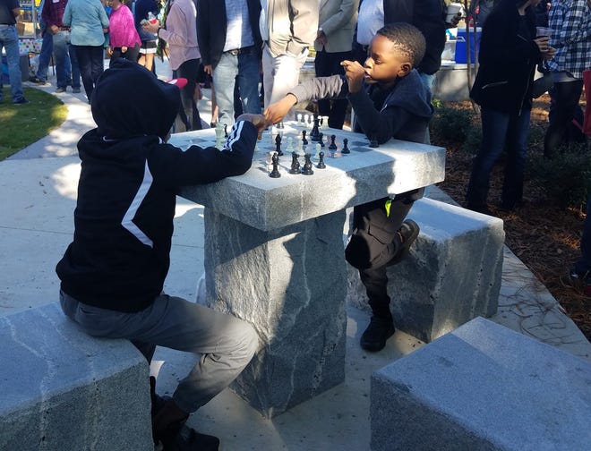 Two children play at the new chess board at Cobbham Triangle Park on Sunday, Nov. 10, 2019. [Photo by Caitlin O'Donnell/Athens Banner-Herald]