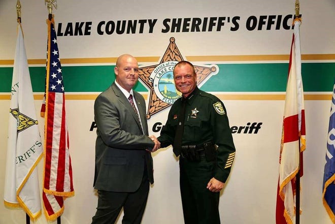 Lake County School District Safety and Security Specialist Jimmer Roy, left, was sworn in as a reserve deputy with the Lake County Sheriff’s Office by Sheriff Peyton Grinnell on Oct. 22. [Lake County Schools/Facebook]