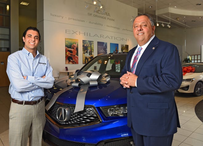 Jack Hanania, Jr. (left) and father Jack Hanania stand next to a new Acura SUV in their showroom in this 2018 file photo. [Bob Mack/Florida Times-Union]