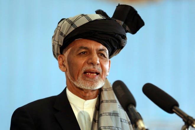 Afghan President Ashraf Ghani speaks to journalists in September near the presidential palace in Kabul, Afghanistan. President Ghani said Tuesday that his government has released three Taliban figures in effort to have the insurgents free an American and an Australian professor they abducted in 2016. [RAHMAT GUL/THE ASSOCIATED PRESS]
