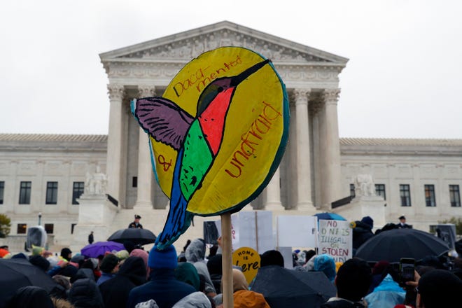 People rally outside the Supreme Court as oral arguments are heard in the case of President Trump's decision to end the Obama-era, Deferred Action for Childhood Arrivals program on Tuesday. [JACQUELYN MARTIN/THE ASSOCIATED PRESS]