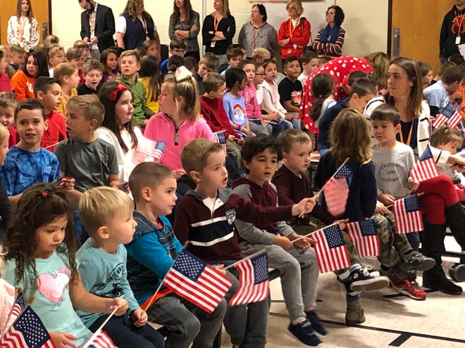 Pre-K students at Lafayette Township School wave American flags as part of the school’s Veterans Day assembly Monday. [Photo by Kyle Morel/New Jersey Herald (NJH)]
