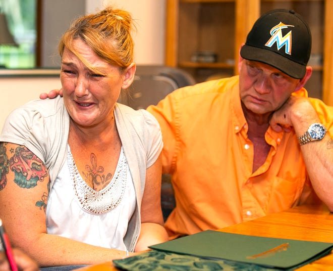 Tammie Ballentine breaks down in tears while being consoled by her husband, Mark Weller, as she talks about her daughter Brooke Ford at their home in Ocala Tuesday afternoon. [Doug Engle/Ocala Star-Banner]
