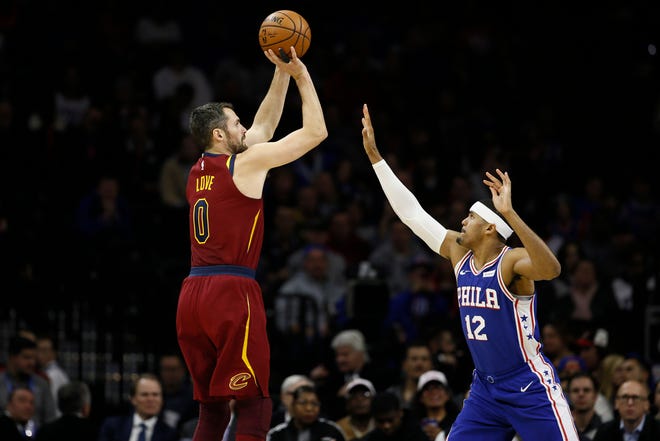Cleveland Cavaliers' Kevin Love, left, goes up for a shot against Philadelphia 76ers' Tobias Harris during the first half of an NBA basketball game, Tuesday, Nov. 12, 2019, in Philadelphia. (AP Photo/Matt Slocum)