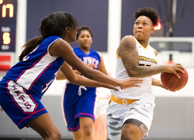 Gulf Coast's Tatiana Jones goes up for a shot while being defended by Lurleen B. Wallace's Jasmine Lewis on Tuesday. [JOSHUA BOUCHER/THE NEWS HERALD]