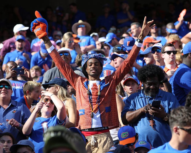 A University of Florida fan poses cheers earlier this season. [Tim Yocum/For the Times-Union]