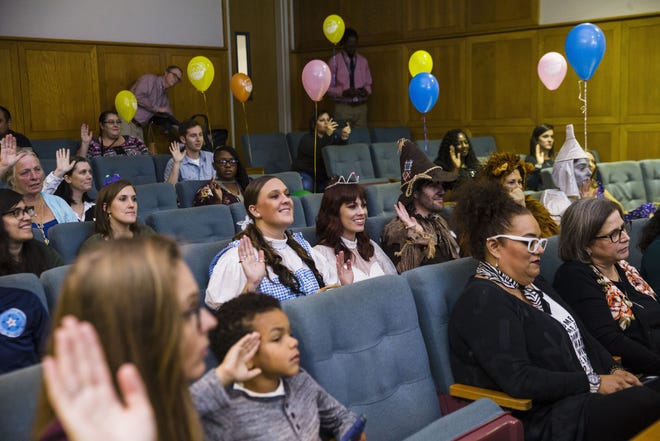 Employees of CASA of Travis County, dressed as characters from “The Wizard of Oz,” attend the adoption proceedings of Cosmo Scott, 17 months, at the Gardner Betts Juvenile Justice Center in 2018 in Austin. More than 20 families adopted more than 50 children as part of a celebration for "Austin Adoption Day" at the center. [AMANDA VOISARD/AMERICAN-STATESMAN]